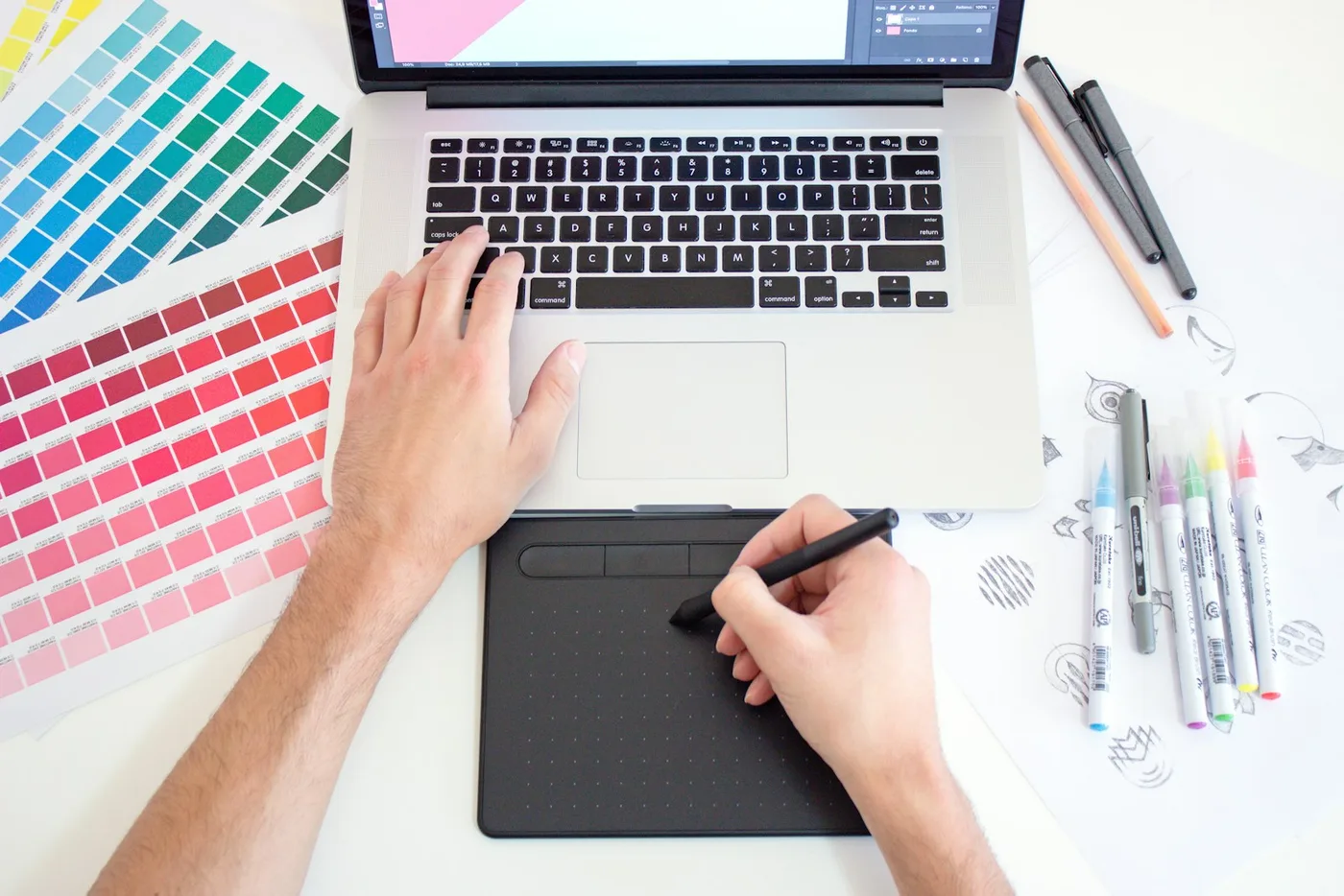 Design work on a drawing tablet and laptop